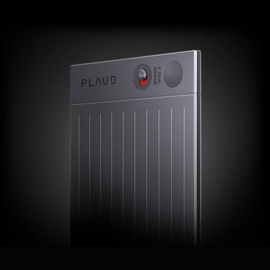 Close-up of a gray Plaud AI voice recorder with vertical ridges, a physical toggle switch, and a recording button.